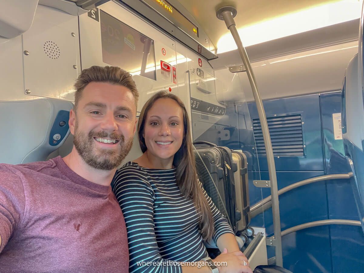 Two tourists sitting on a train from Paris to Bayeux in France