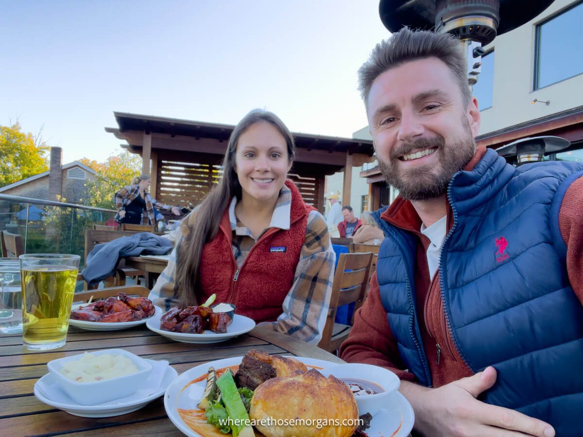 Two people enjoying their meal at Smoke Signals