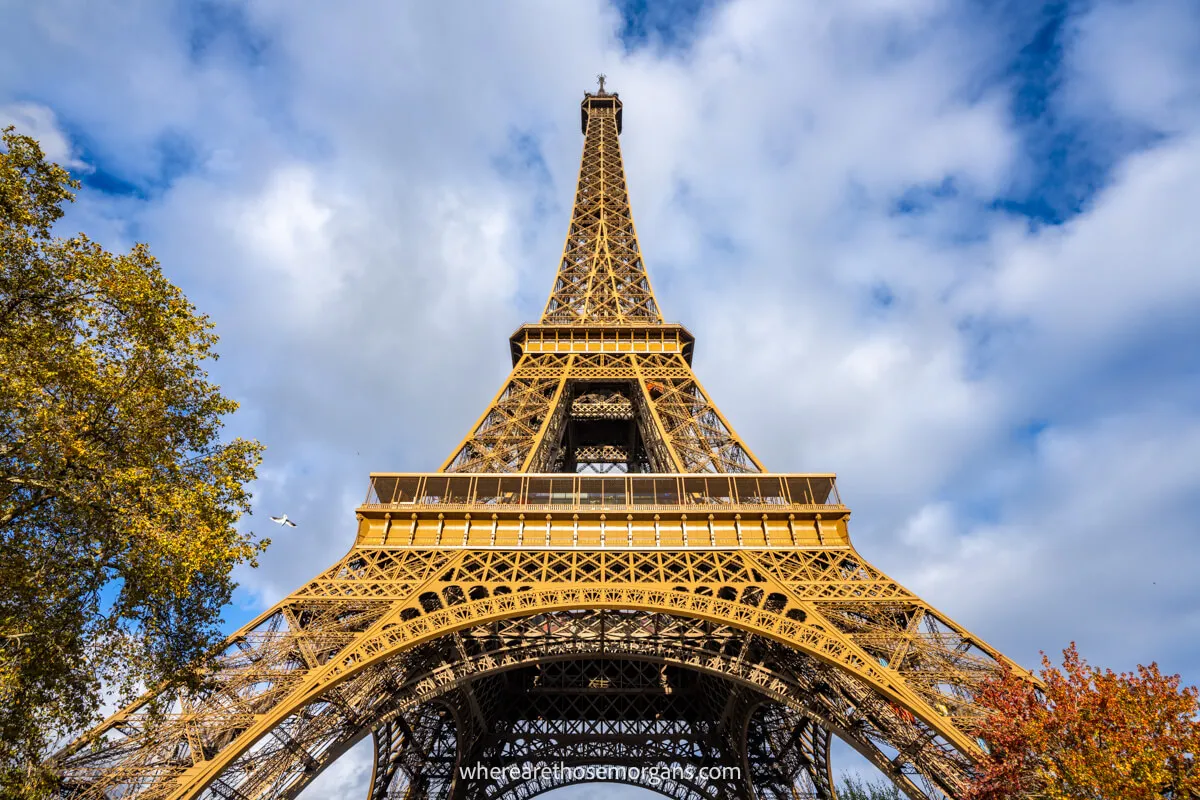 View of the Eiffel Tower looking up from the ground on a cloudy day