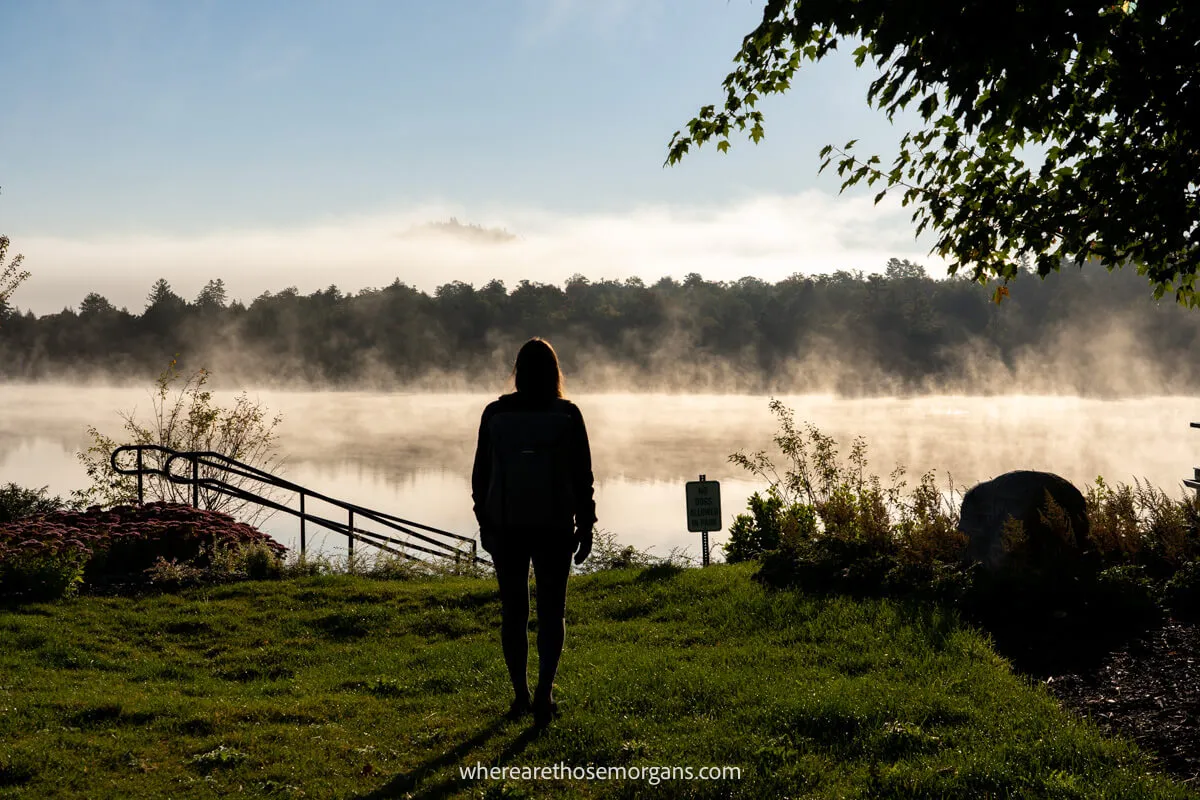 Silhouette of a woman with fog rolling in on Mirror Lake