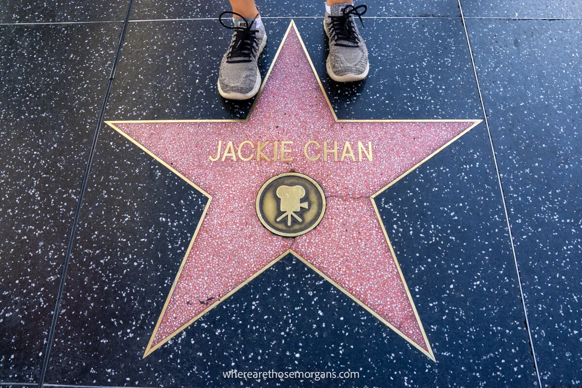 Woman standing next to Jackie Chan's star in Hollywood, California