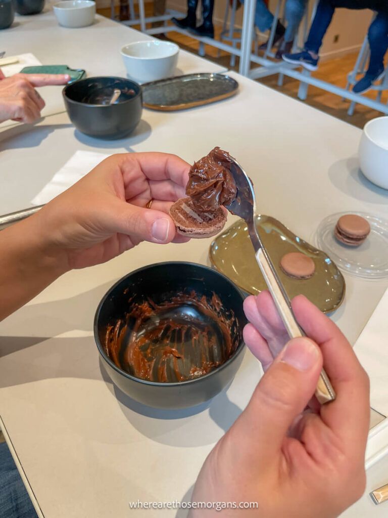 Woman learning how to make ganache during a pastry making class in Paris