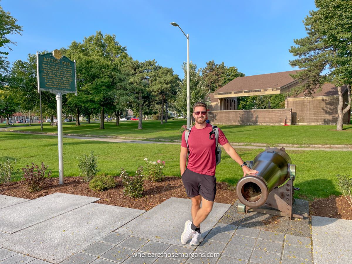 Tourist leaning against a cannon in Battery Park in Burlington, Vermont