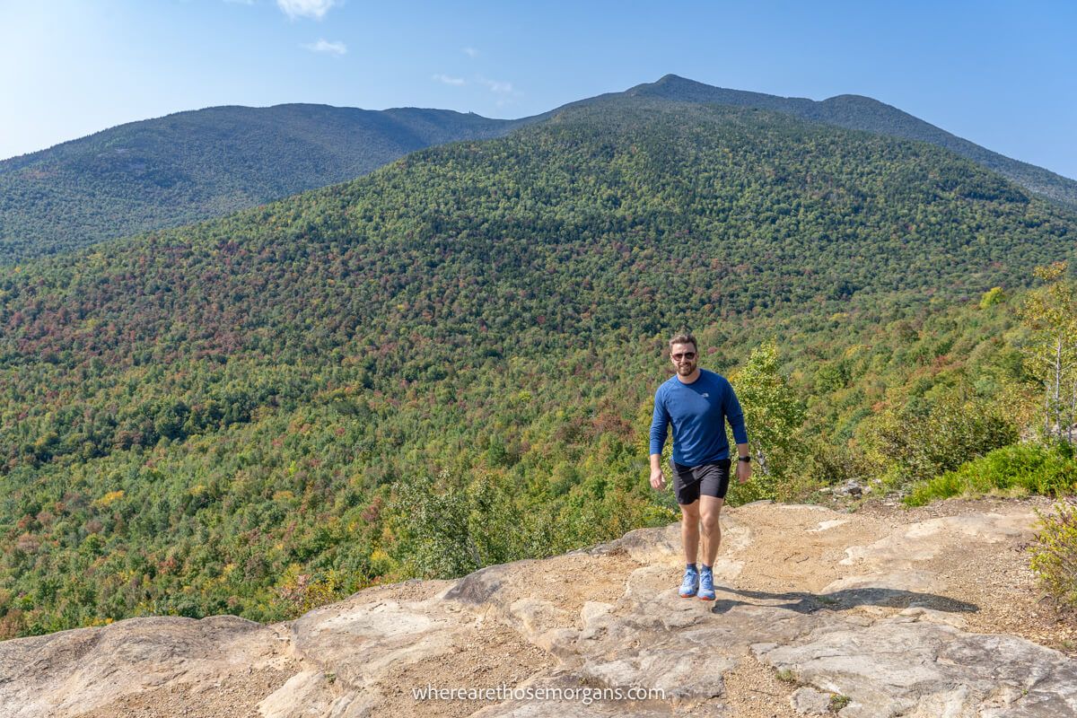 Hiker posing for a picture at the summit of Cobble Lookout