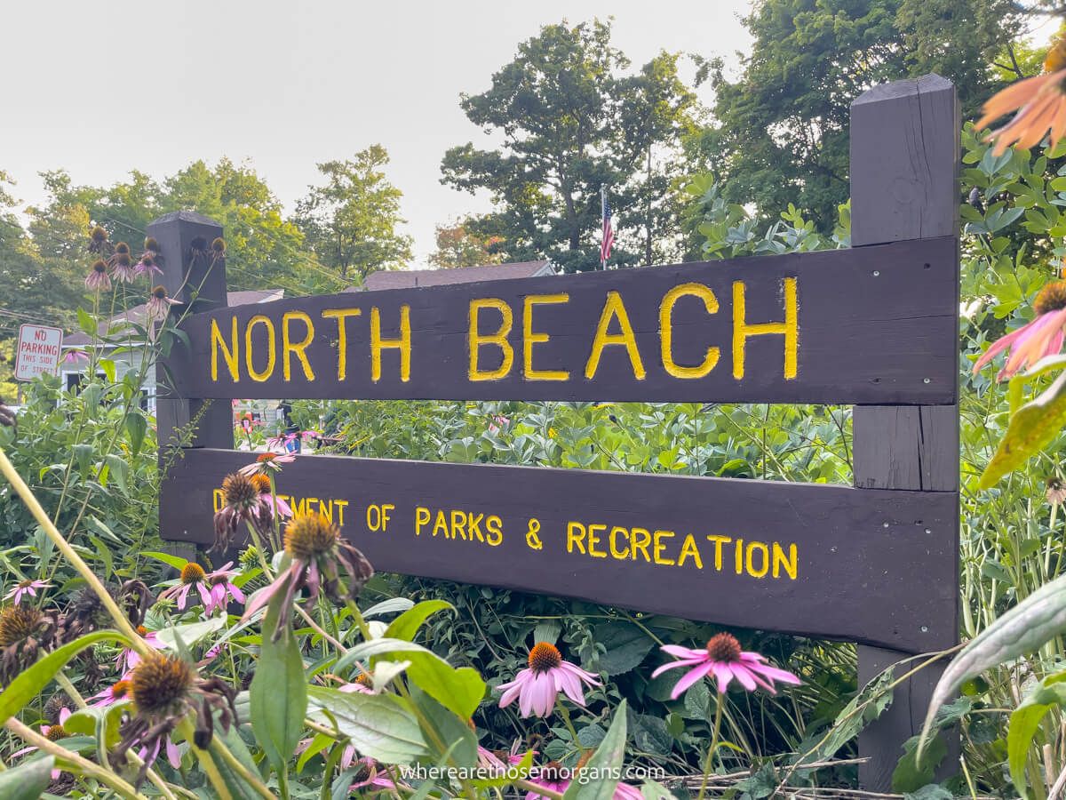 Large wooden brown sign for North Beach