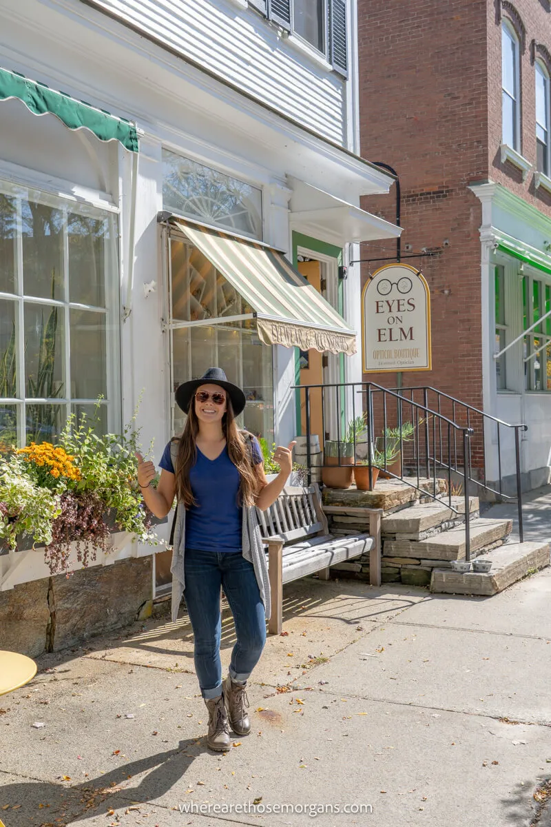 Woman standing outside the Eyes on Elm optical boutique in Woodstock