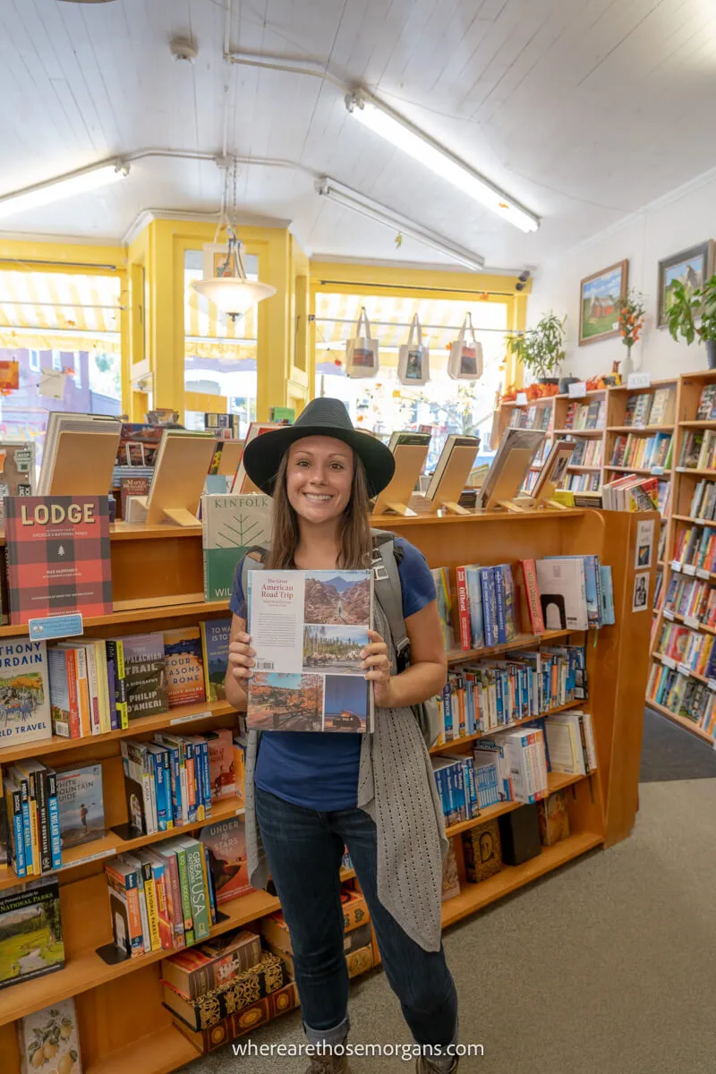 Woman holding up Gestalten's Great American Road Trip in the Yankee Bookstore