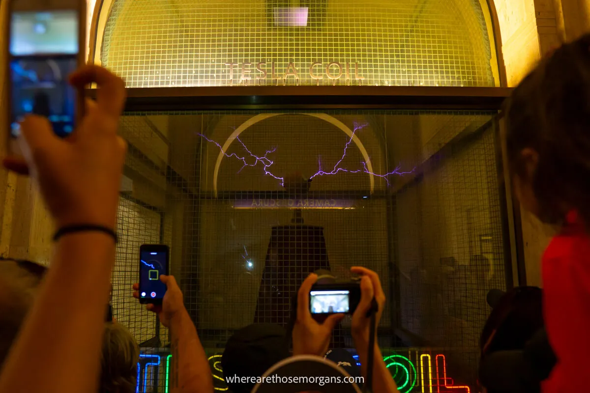 Several tourists taking a photo of a Tesla Coil at the Griffith Observatory