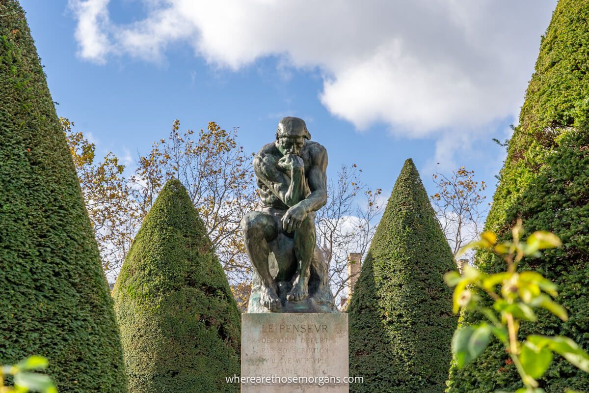 The Thinker sitting in the garden of the Rodin Museum in Paris