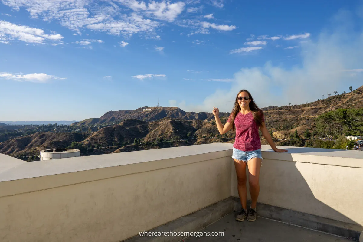 Woman pointing to the Hollywood Sign from a balcony at the Griffith Observatory