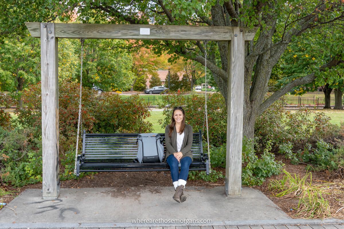 Woman sitting on a wooden bench at Waterfront Park along Lake Champlain in Burlington, Vermont