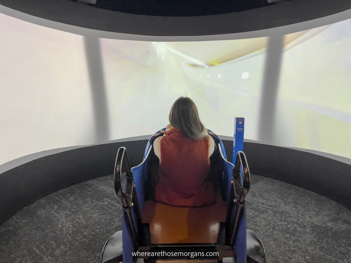 Woman playing an interactive toboggan game at the Lake Placid Olympic Museum