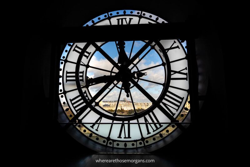 Photo of a large clock with windows providing views over Paris