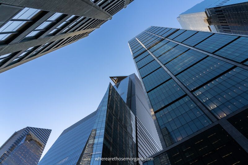 Looking up at the tops of skyscrapers from the ground in NYC