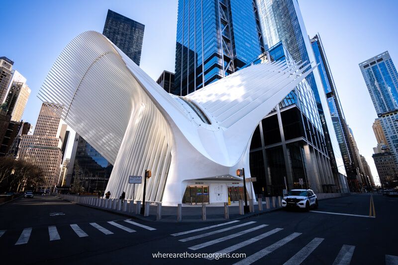 A white and dove shaped building in New York City surrounded by tall skyscrapers