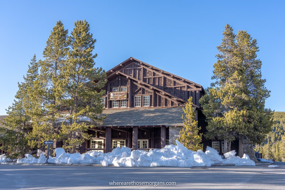 Exterior photo of Old Faithful Lodge a wooden structure with trees around it on a clear day