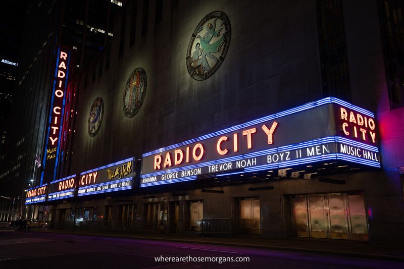 Radio City building in NYC lit up purple at night