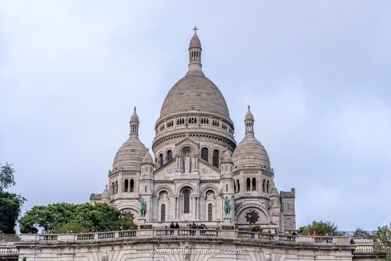 Looking up at Sacre-Coeur Basilica in Paris with its white domes