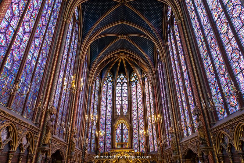 Enormous purple colored stain glass windows inside Saint-Chapelle leading up to the roof