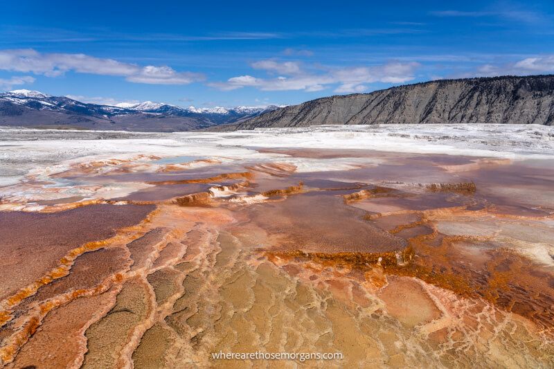 Colorful terraces in Yellowstone National Park leading to mountains in the distance