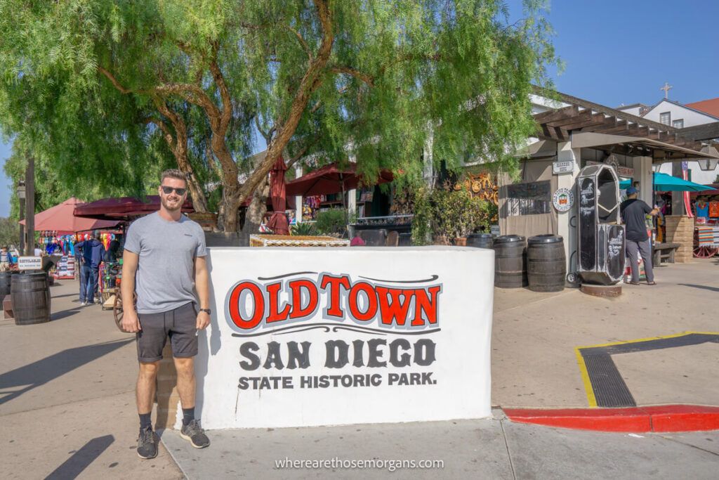 Person standing in from of the Old Town sign to San Diego State Historic Park