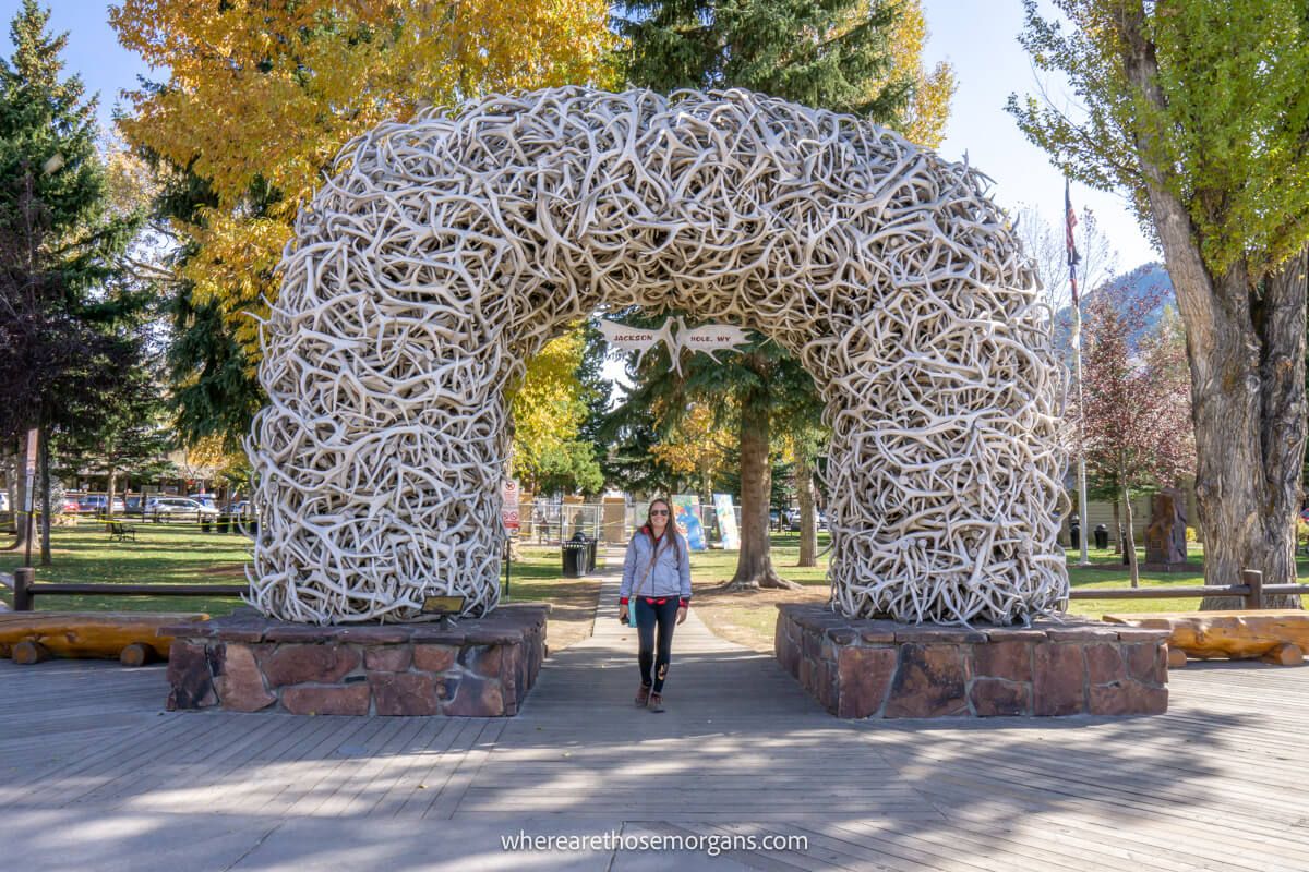 Tourist stood underneath an elk antler arch in Jackson Wyoming