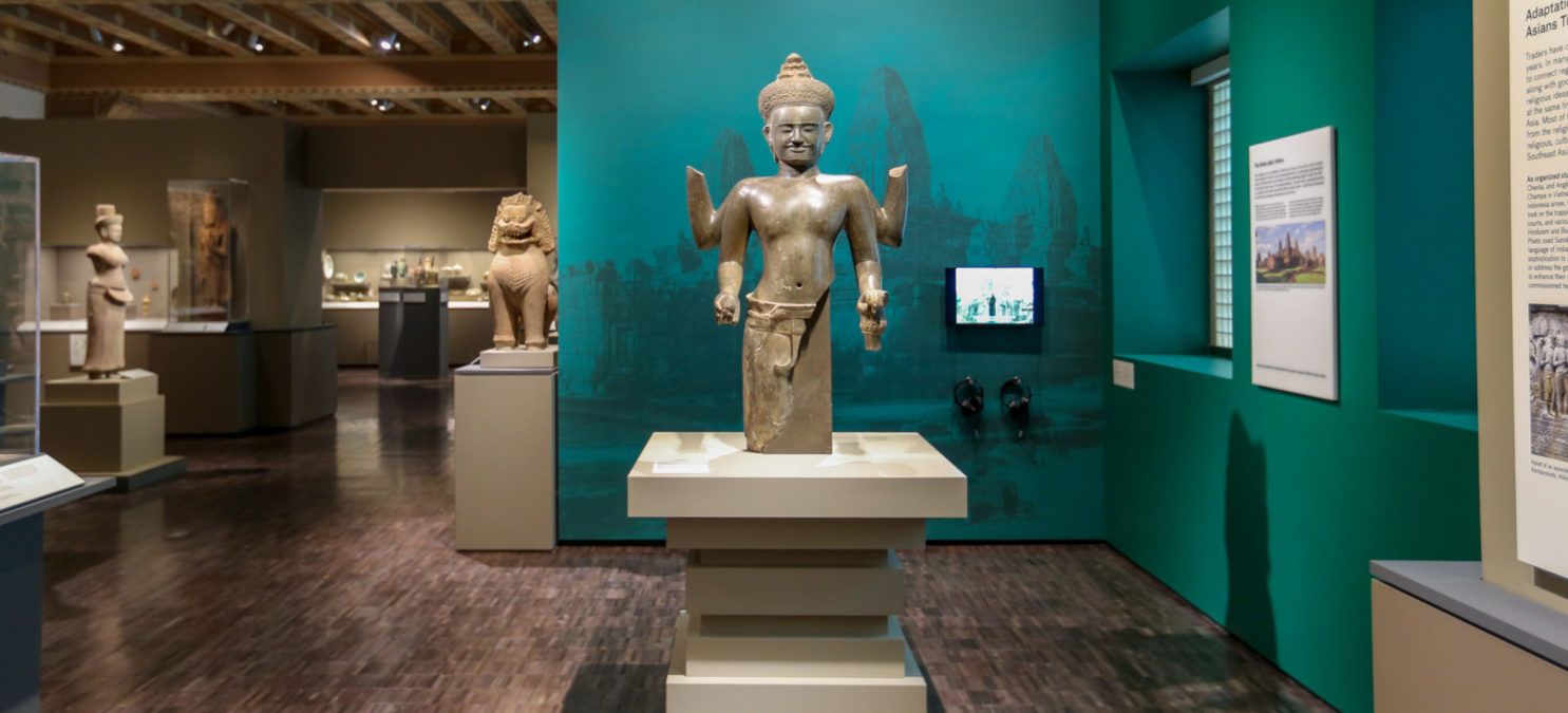 Exhibit of a small sculpture inside a museum with Asian art