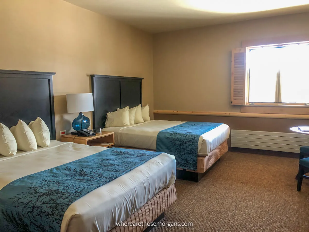 Photo of a room at Canyon Lodge with two large beds and light streaming in