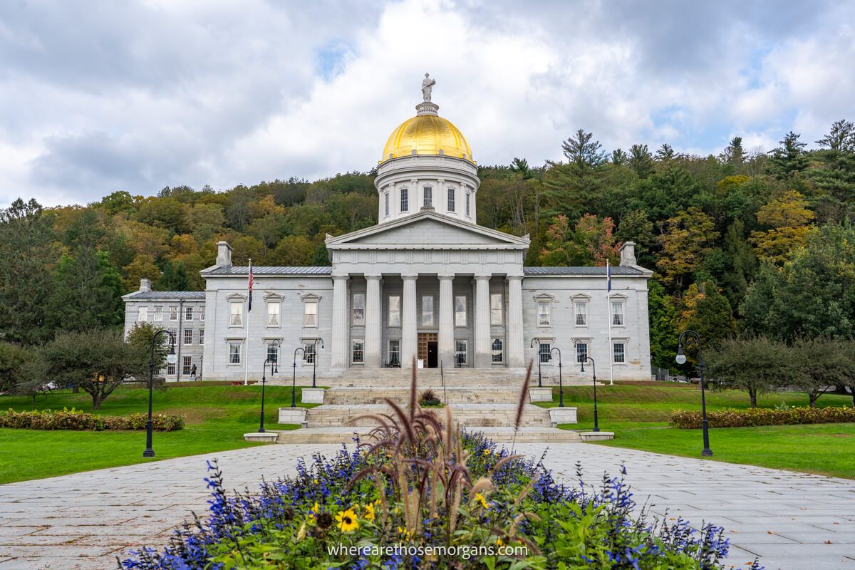 Photo of the grand looking Vermont State House with flowers in the foreground