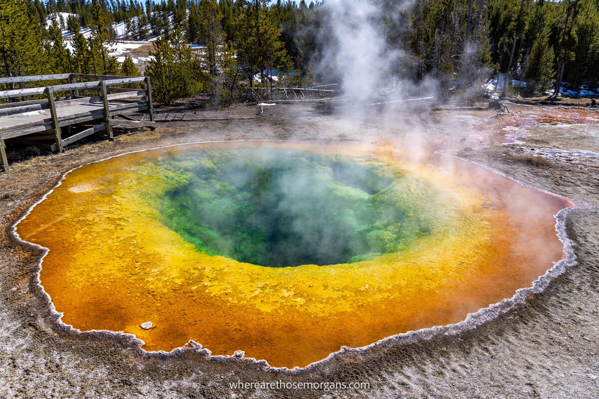 Photo of a vibrant hot spring in Yellowstone called Morning Glory Pool with deep orange, yellow, green and blue colors