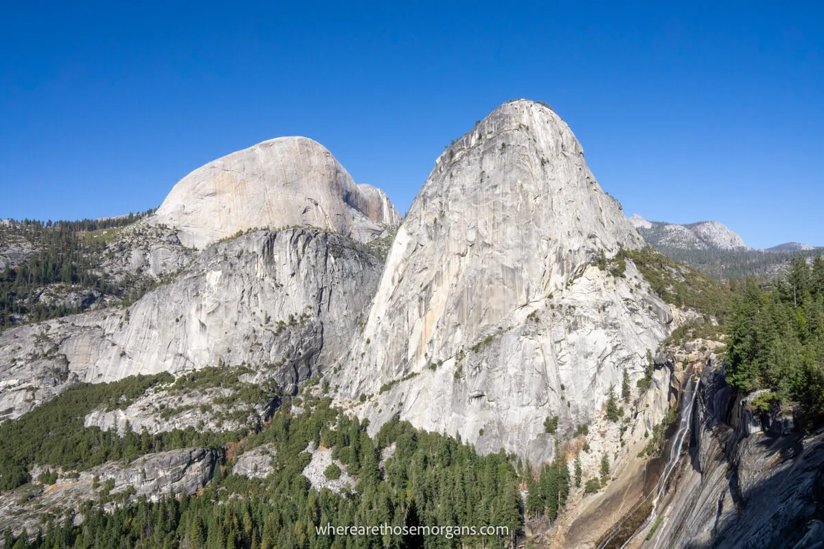 Photo of Nevada Falls, Liberty Cap and the back of Half Dome from John Muir Trail stunning granite monoliths bursting out from trees